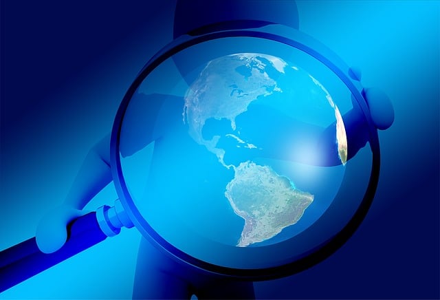 magnifying glass surrounds blue globe